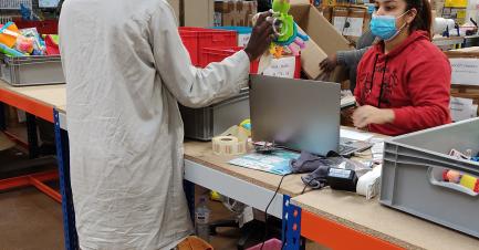 Rejoué's team selecting toys in the warehouse.