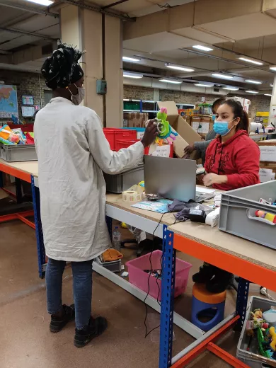 Rejoué's team selecting toys in the warehouse.