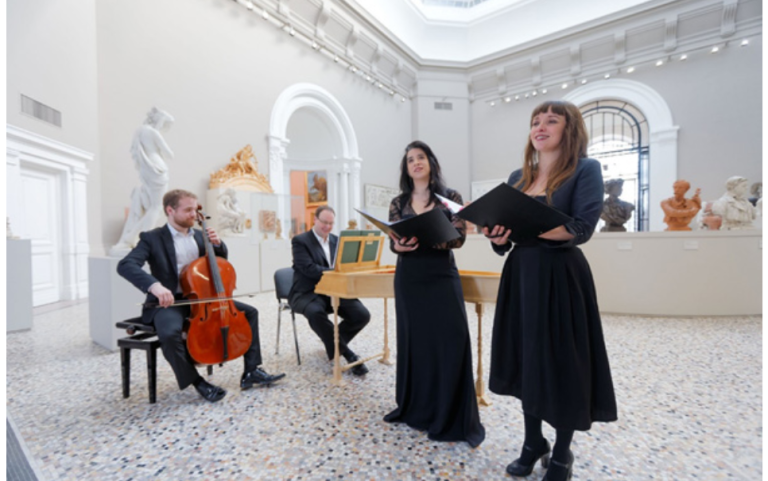Deux chanteuses lyriques debout, un violoncelliste et un pianiste assis